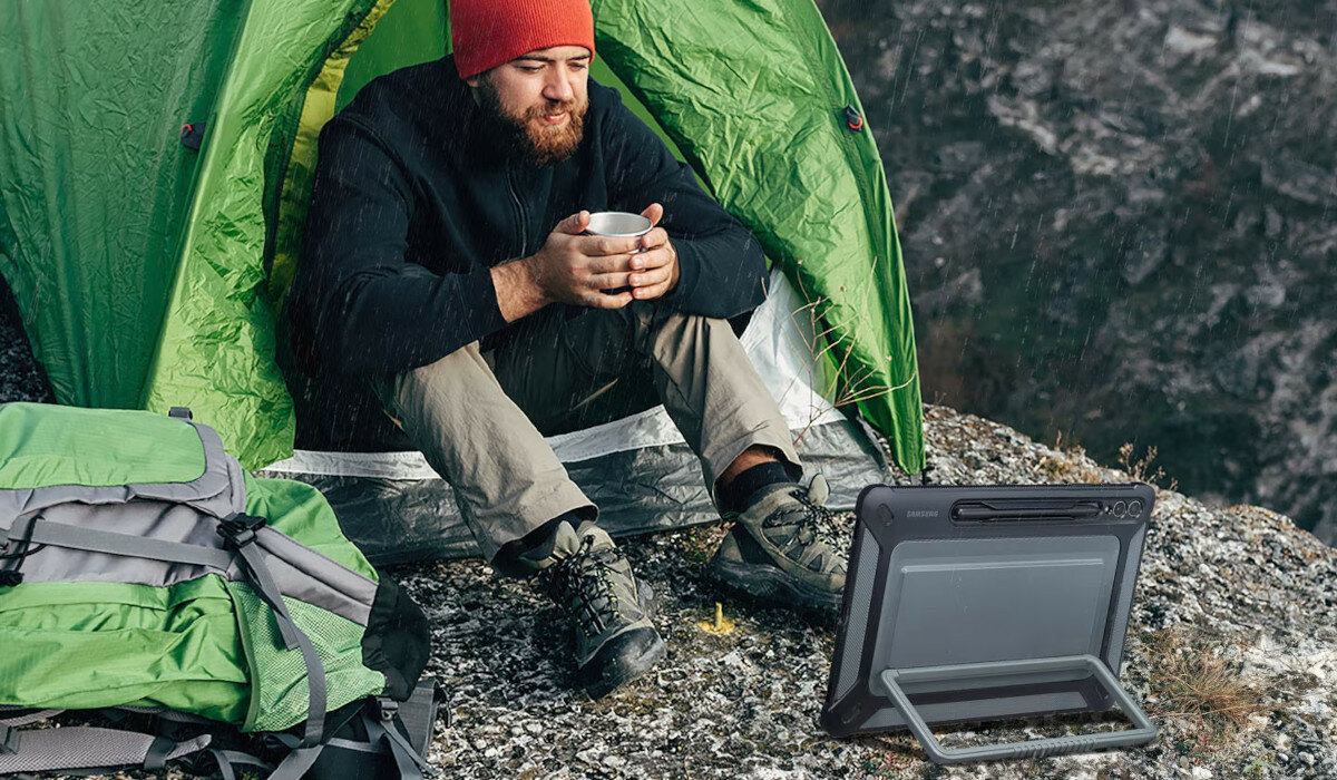 Etui Samsung Outdoor Cover do Tab S9+ czarne tablet w etui naprzeciwko mężczyzny w namiocie